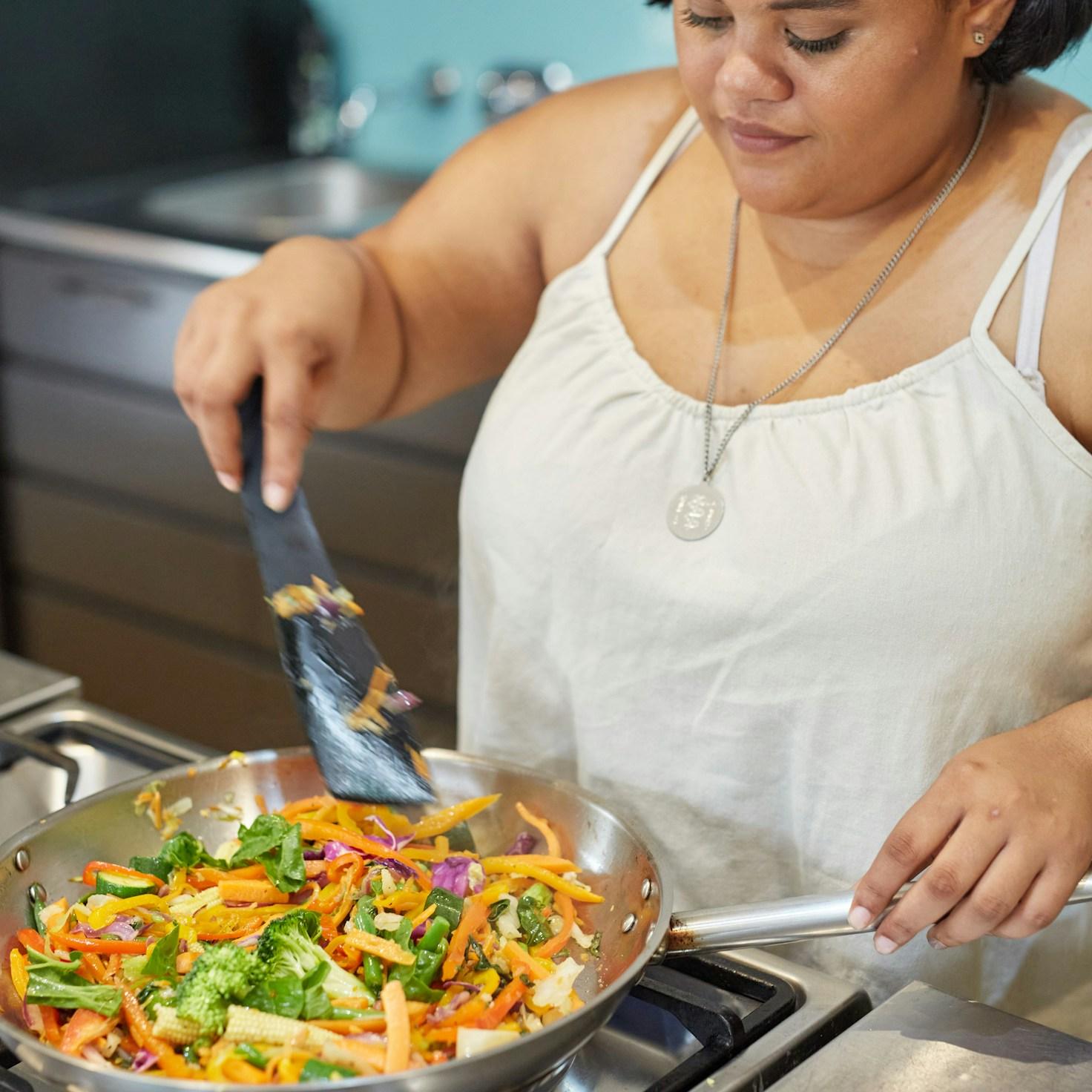 Diverse group of community members sharing a meal together, showcasing the social bonds formed through collaborative cooking